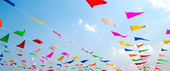 Multi Colored Triangular Flags Hanging in the Sky at an Outdoor