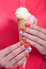 Girl holding ice cream in hands. Hands with beautiful colored manicure closeup