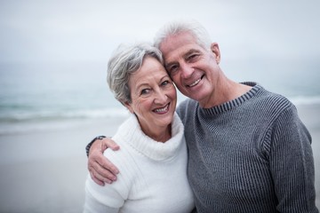 Happy senior couple embracing on the beach