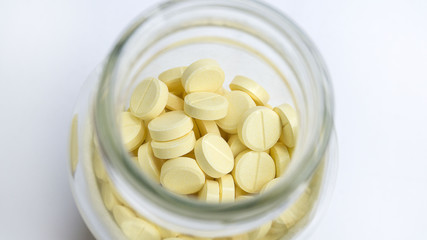 Prescription pill bottle spilling pills on to surface isolated o