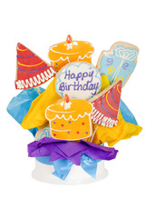 Happy birthday cookies in the shape of cake, gifts, and party hats