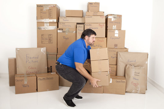 Man lifting and holding moving boxes