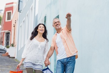 Man pointing to woman against building