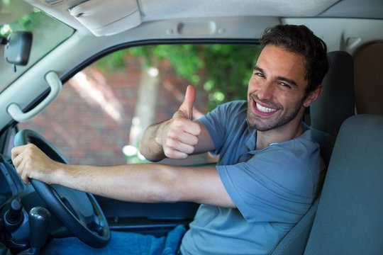 Portrait of happy man showing thumbs up