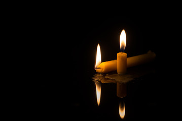 light of candle in black background