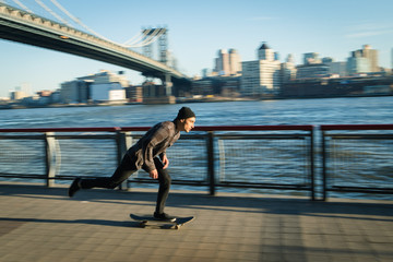 Young skateboarder cruise down on pedestrian walk
