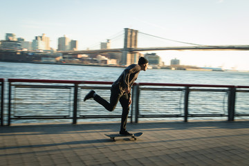 Young skateboarder cruise down on pedestrian walk