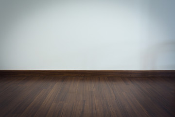 empty room, white mortar wall background and wood laminate floor