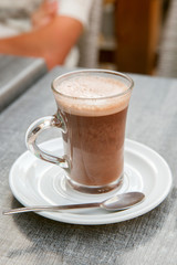 a cup of cocoa on the table in street cafe