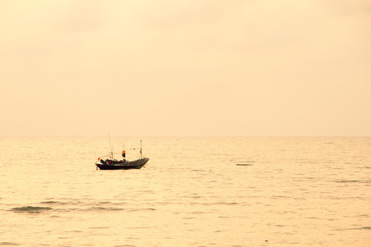 Small lonely fishing boat floating on flat surface of adriatic s