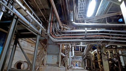 Fototapeta premium Equipment, cables and piping as found inside of a modern industr