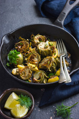 fried artichokes with garlic and lemon on pan