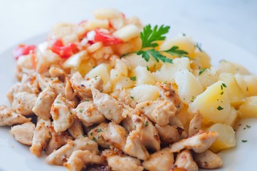Chicken curry nuggets with potato and vegetables on plate