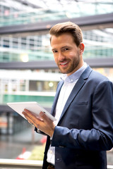 Young attractive business man using tablet