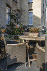 Brown table and several chairs on the european street