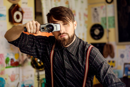 stylish hipster bearded man holding old film camera
