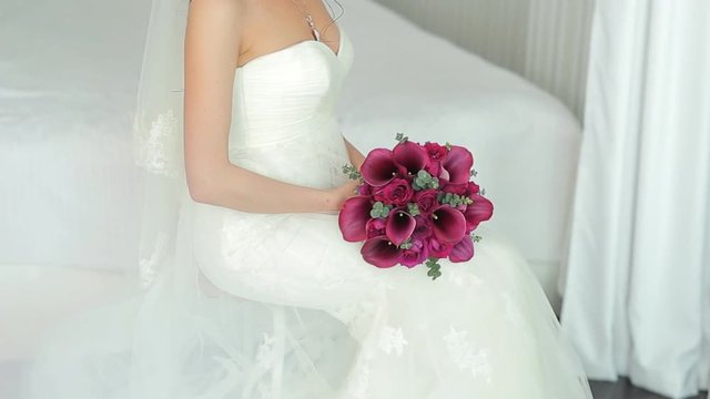 The Bride holds a wedding bouquet