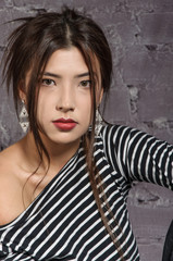 Portrait of an Asian girl wearing a striped shirt