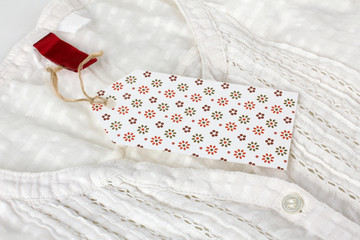 white tag on the clothes or fabric with buttons closeup