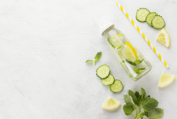 Lemonade with cucumber, lemon and mint on a white background. Sp