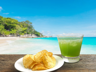 glass of apple juice and potato chips