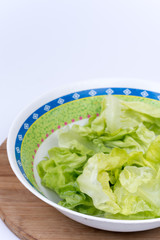 Green lettuce salad with copy space over white