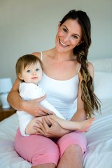 smiling woman holding a cutee baby