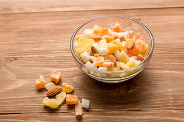 The mixture of nuts and dried fruit in a glass Cup on the table