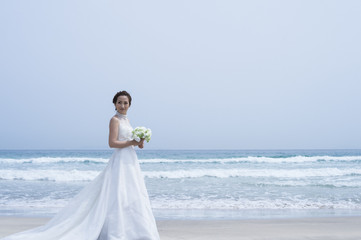 Fototapeta na wymiar Bride're shooting the wedding photos on the beach