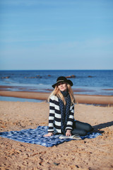 girl reading a book sitting on the beach