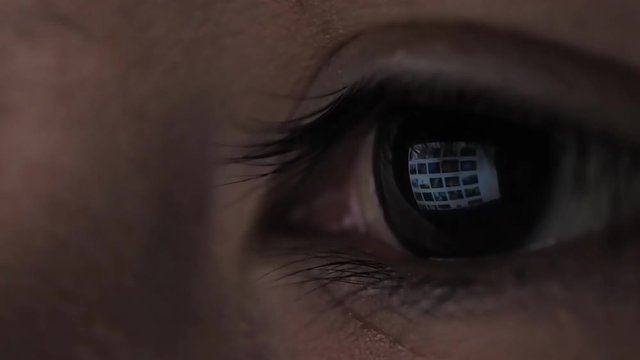 Closeup shot of girl eye surfing internet at night