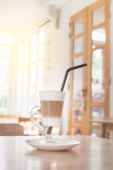 Cup of Hot  Latte Layer Coffee on wood table