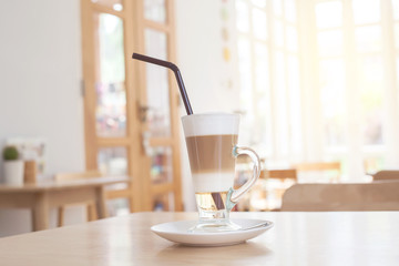 Cup of Hot  Latte Layer Coffee on wood table
