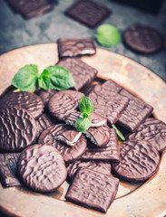 Chocolate peppermint cookies.Mint. Peppermint. Menthol. Black chocolate with peppermint cream. Black chocolate with mint stuffing. Menthol chocolate with mint leaves. Toned images.