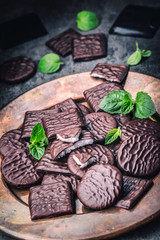 Chocolate peppermint cookies.Mint. Peppermint. Menthol. Black chocolate with peppermint cream. Black chocolate with mint stuffing. Menthol chocolate with mint leaves. Toned images.