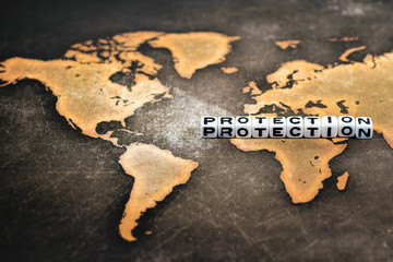 Cubes with text, PROTECTION, on world map