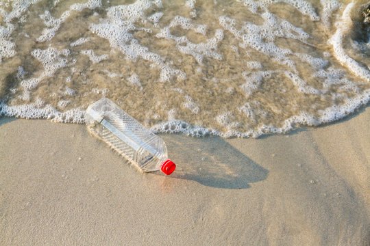 plastic bottle of water drink on the beach, Concept on the beach