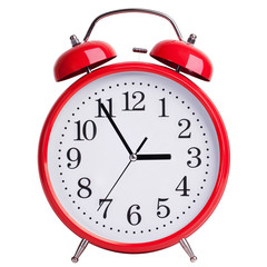 Round alarm clock shows five minutes to three