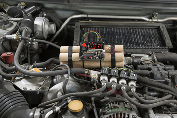 TNT time bomb near wheel of car.