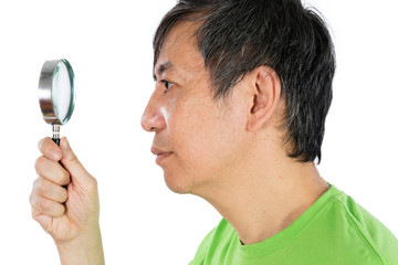 Asian Chinese Man Looking through a Magnifying Glass