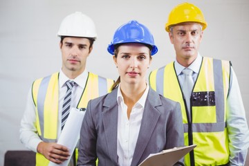 Portrait of serious architects with clipboard 