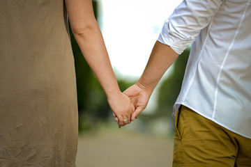 Man and woman holding his hands in nature