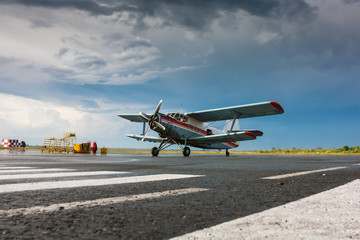 Fototapeta na wymiar Retro plane on the airport apron after the rain