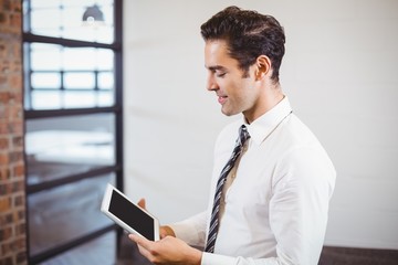 Smart businessman using digital tablet in office