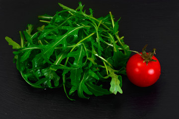 Healthy and diet food: arugula and tomato.