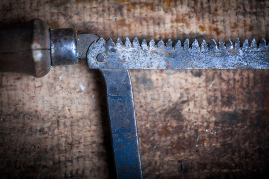 Hacksaw on wooden plank