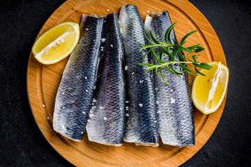 Raw herrings fillets sprinkled with salt