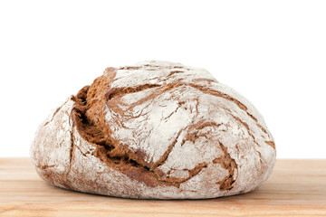 Homemade bread on wooden board isolated on white background