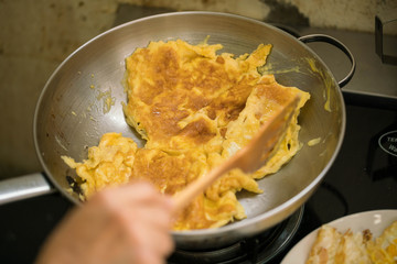 cooking scene ; Omelette on frying steel pan - close up