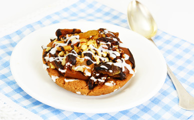 Homemade Cakes: Cake on Plate with Nuts, Chocolate and Raisins.